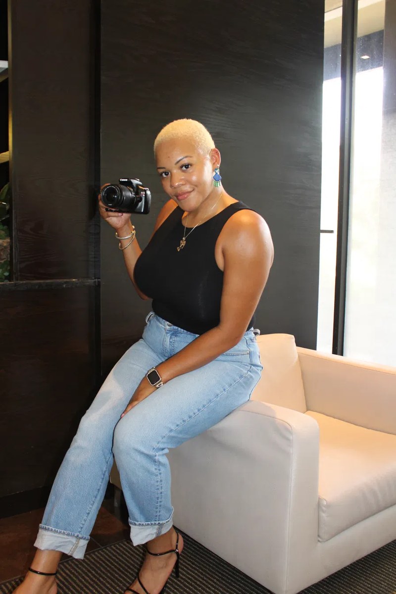 Arielle Hart of A.Hart Marketing & Media holding her camera