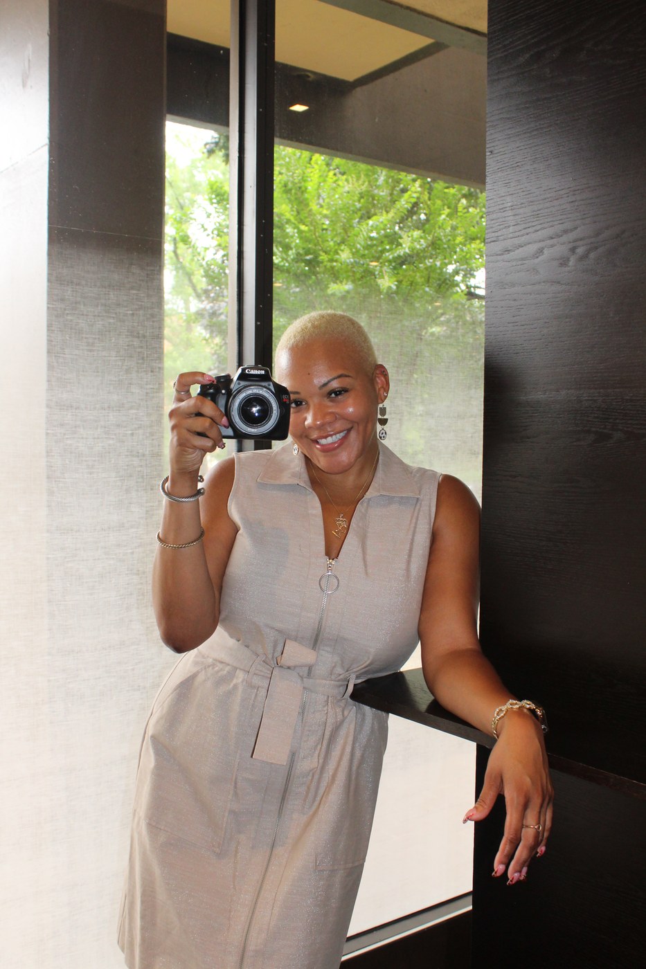 Arielle Hart of A.Hart Marketing & Media holding her camera