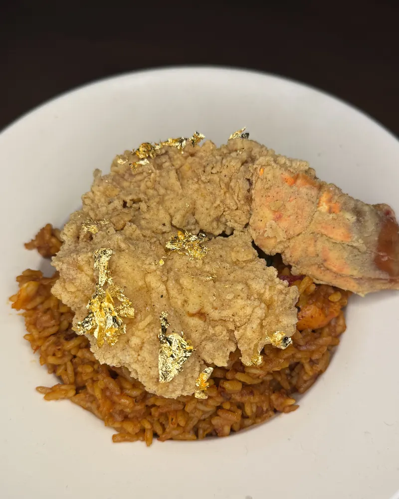 Fried seafood topped with gold leaf over seasoned rice