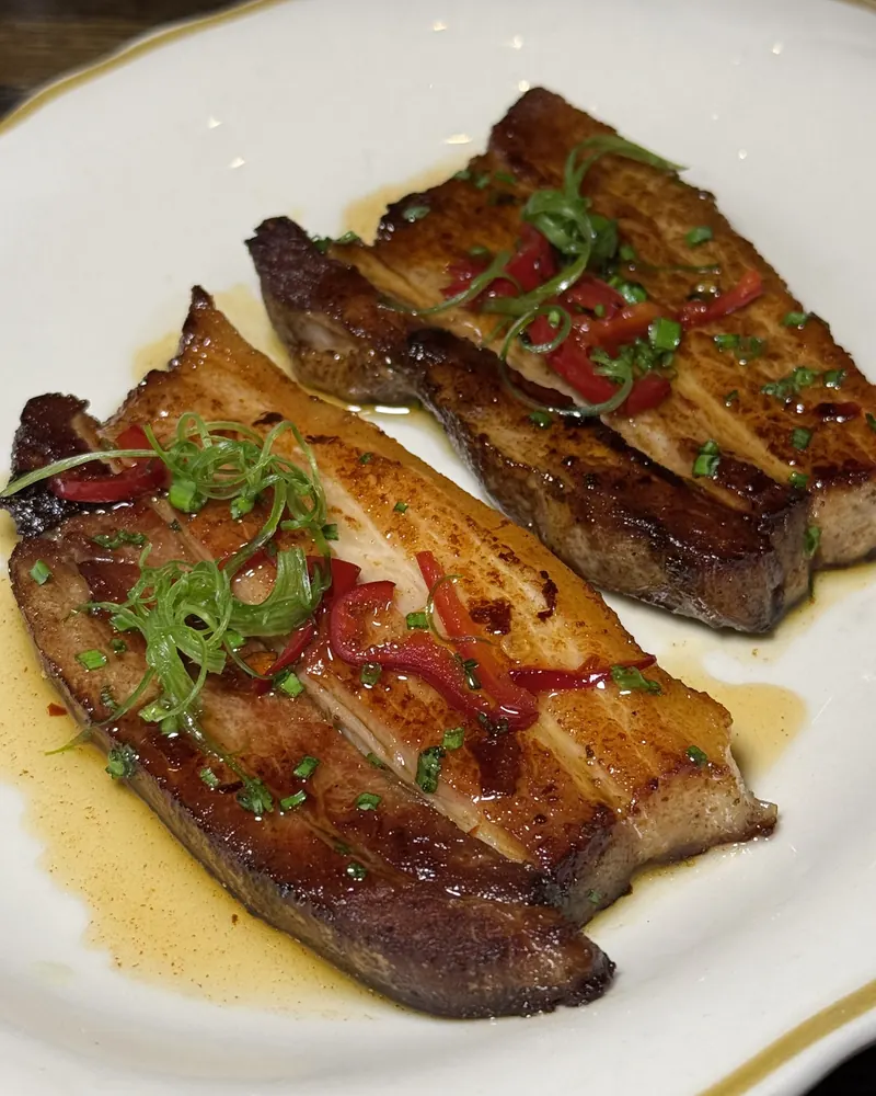 Seared pork belly with sliced chilies and scallions